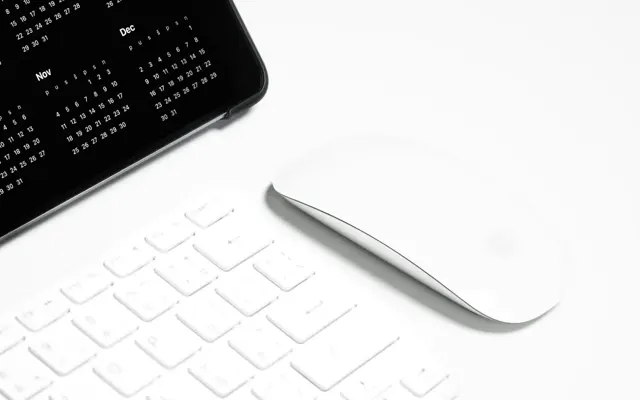 Keyboard and tablet in a white workspace